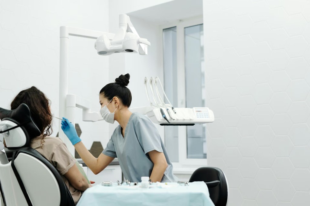 Dentist treating a patient in a bright modern dental clinic